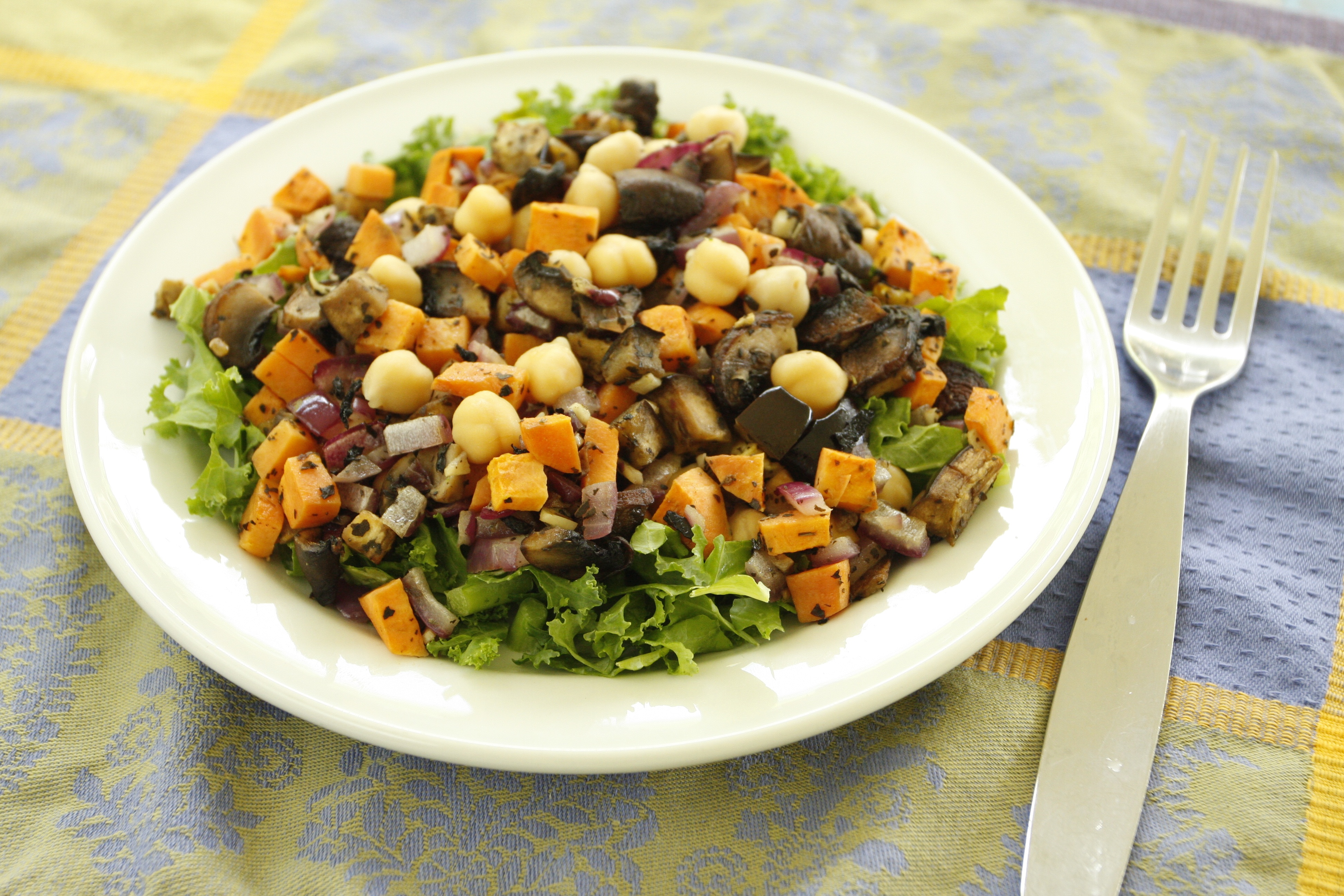 Baked vegetables with chickpeas on salad